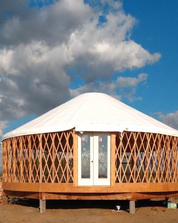 Yurt construction with lattice faming and white roof