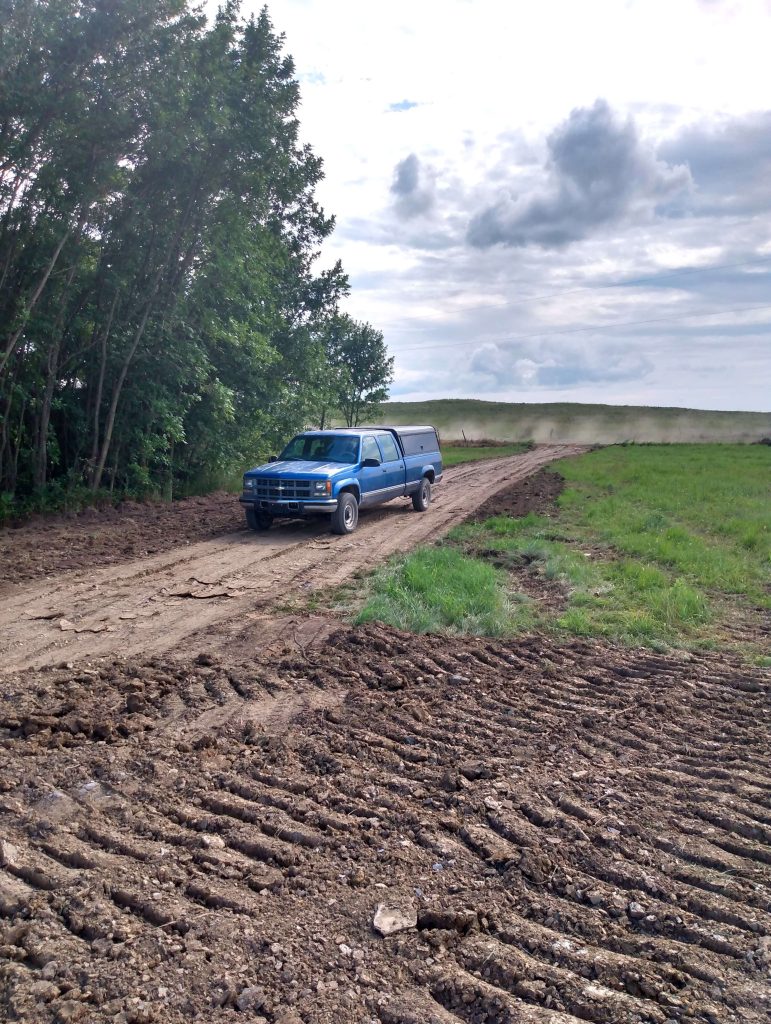Truck on a dirt driveway and a circle dirt pad