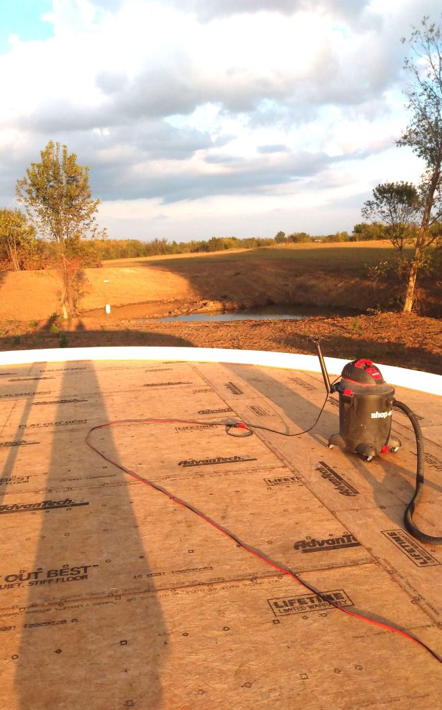 Circle platform with shop vac on top and a pond in the background