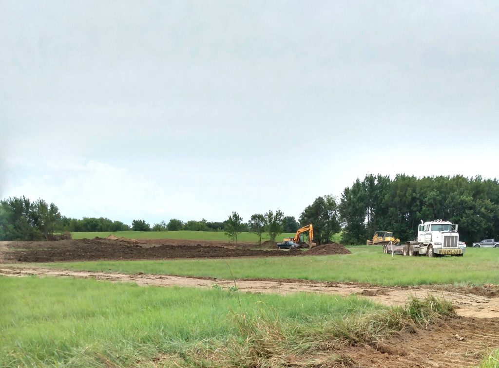 Machinery doing dirt work on a piece of land