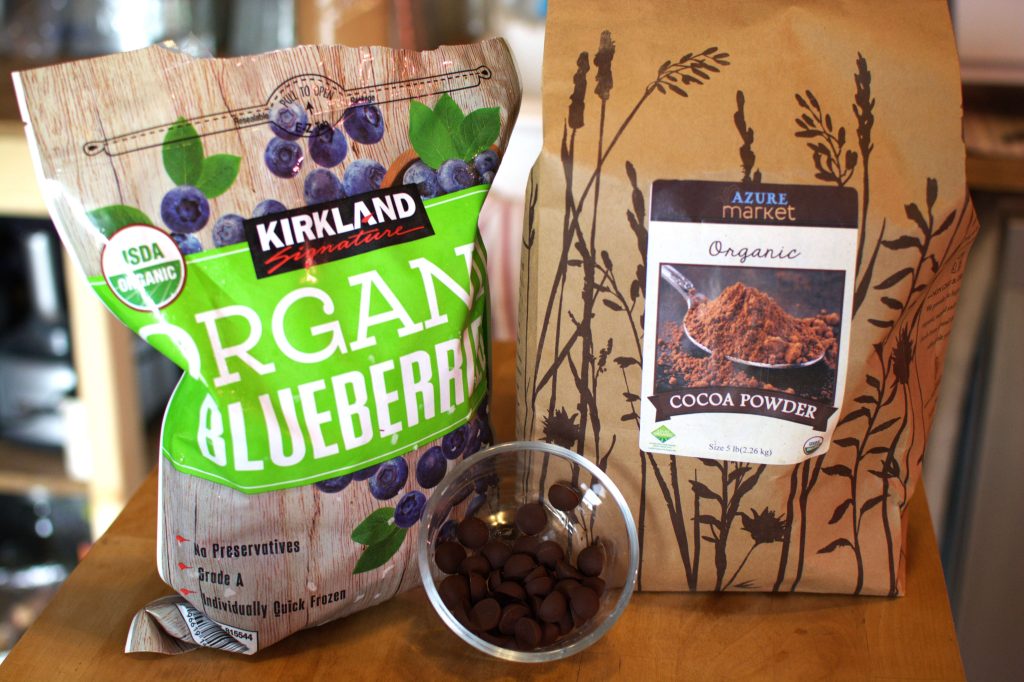 blueberries, cocoa powder, and chocolate chips on a counter